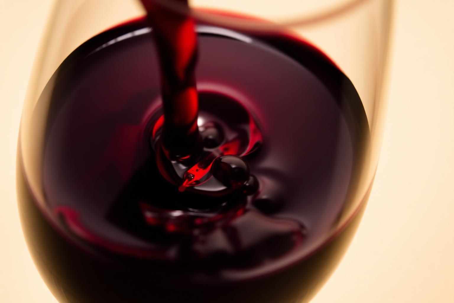 Deep ruby wine swirling in a glass